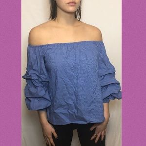 blue off the shoulder ruffle shirt
